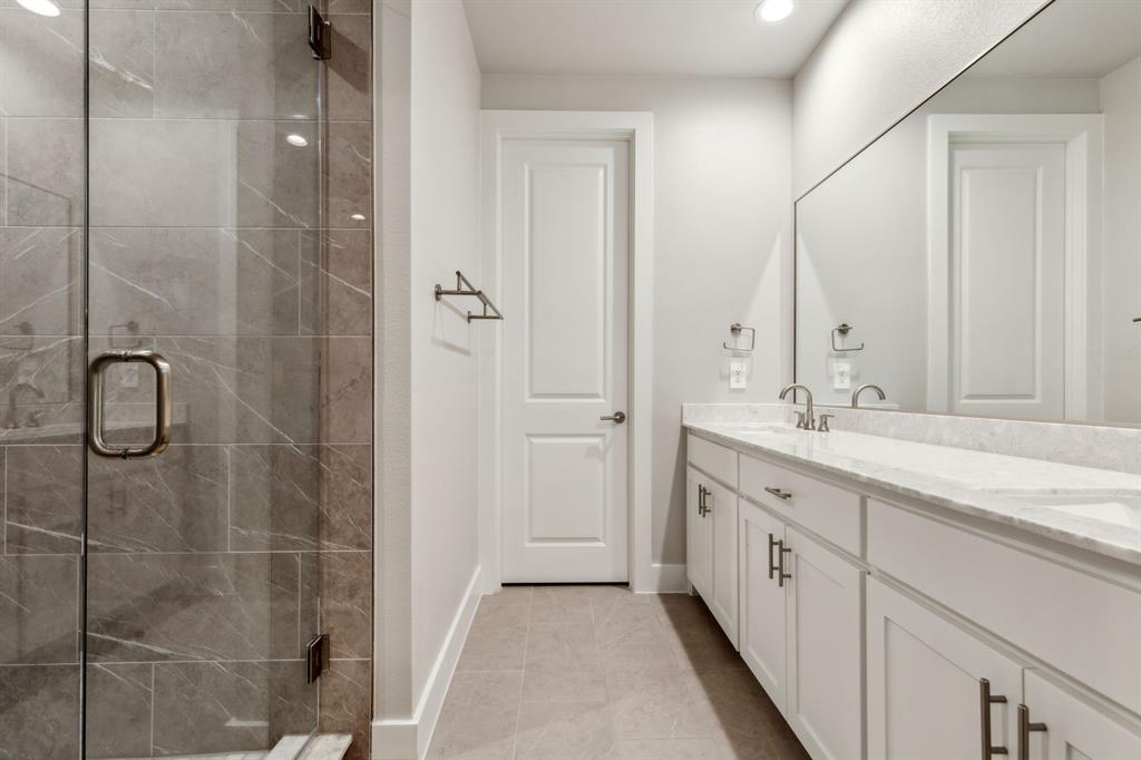 4109 Maison Ridge Dallas, TX 75219 - Photo 19 of 39 a spacious bathroom with a shower and a sink