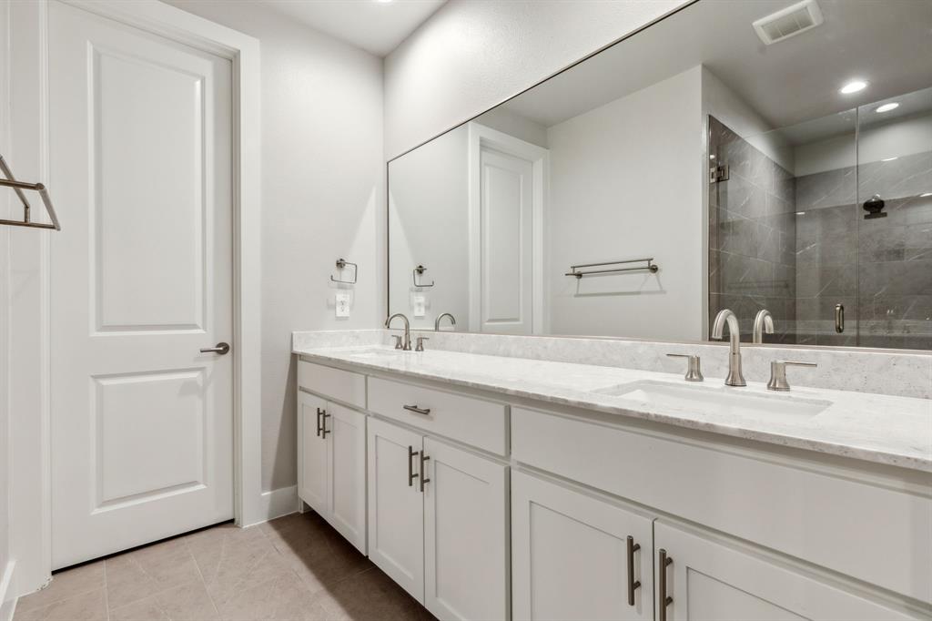 4109 Maison Ridge Dallas, TX 75219 - Photo 20 of 39 a bathroom with double sink and a mirror