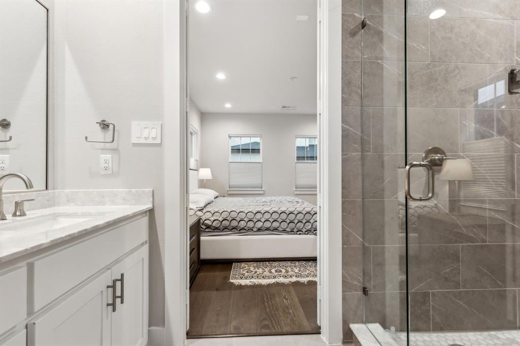 4109 Maison Ridge Dallas, TX 75219 - Photo 21 of 39 a en suite bathroom with a granite countertop sink and a mirror