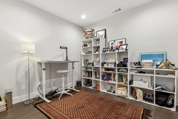 a bedroom with a bed and a painting on the wall