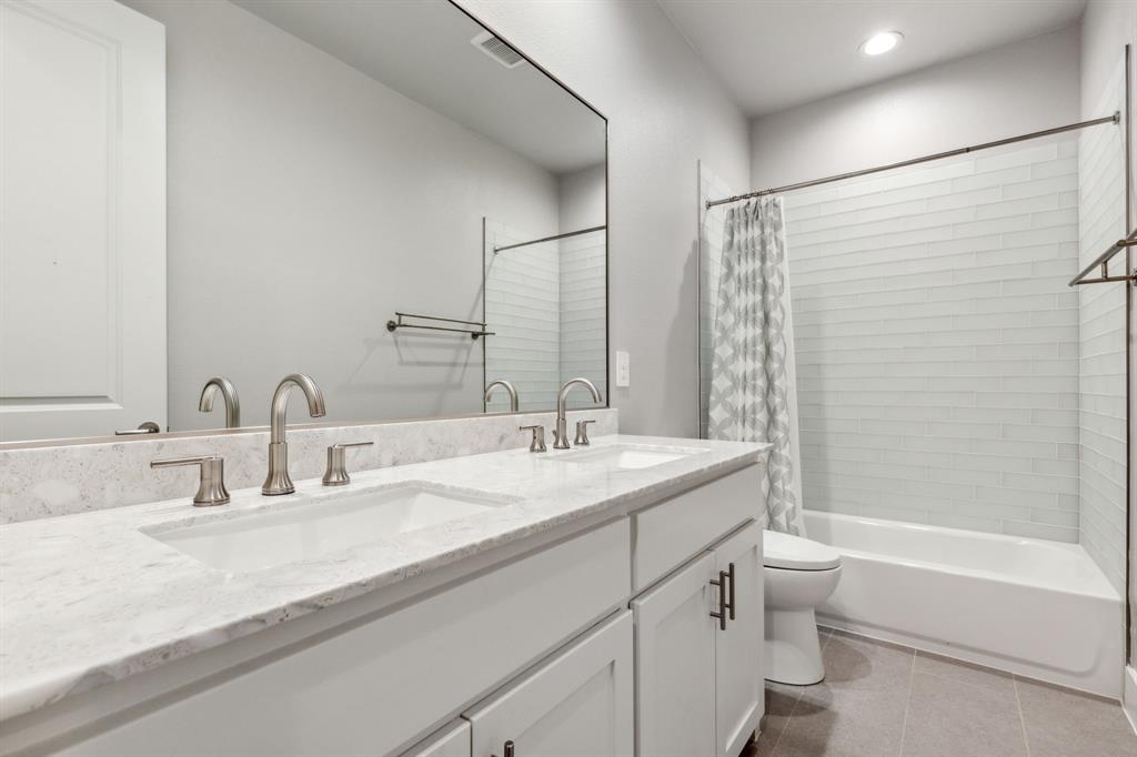 4109 Maison Ridge Dallas, TX 75219 - Photo 24 of 39 a bathroom with a granite countertop sink a toilet and shower