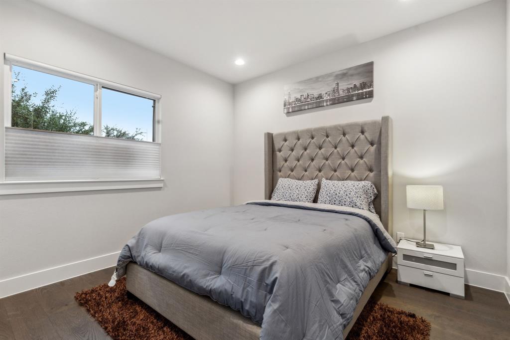 4109 Maison Ridge Dallas, TX 75219 - Photo 25 of 39 a bedroom with a bed and a painting on the wall