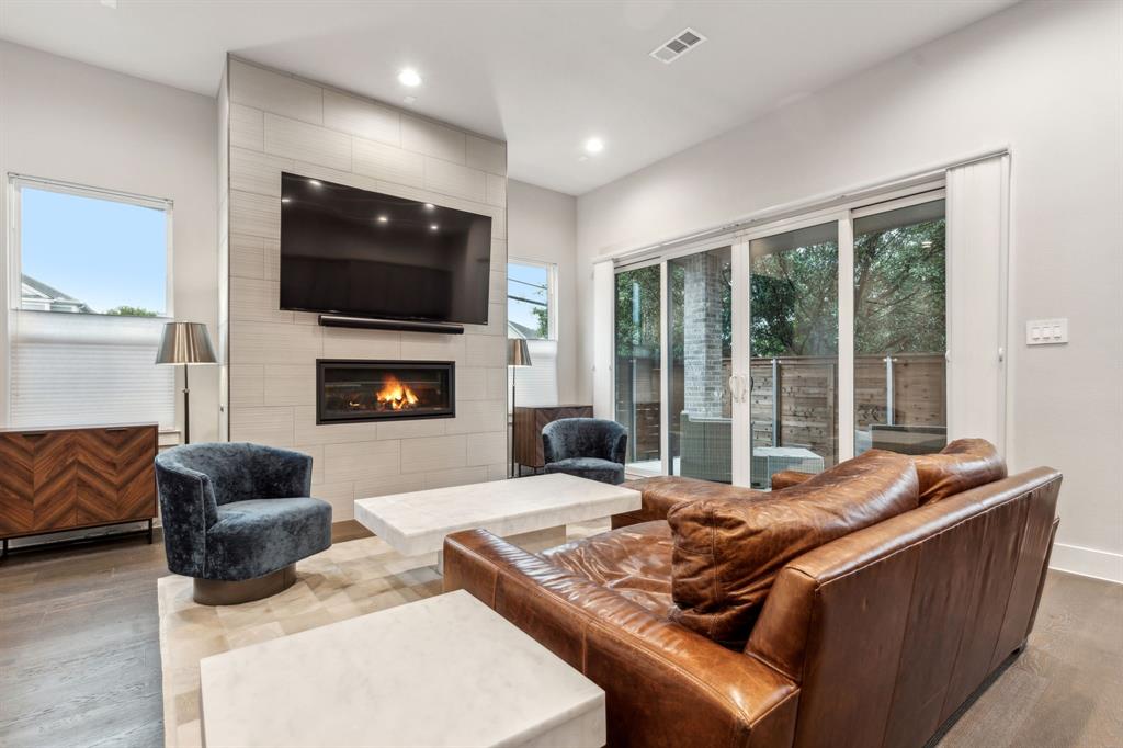 4109 Maison Ridge Dallas, TX 75219 - Photo 4 of 39 a living room with furniture fireplace and flat screen tv