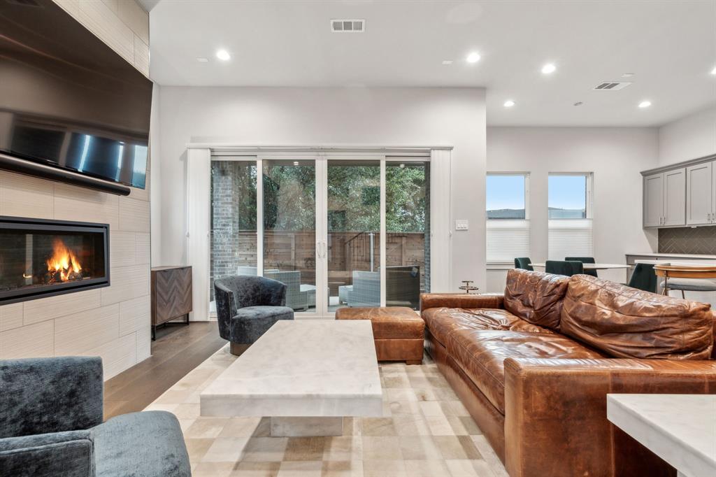 4109 Maison Ridge Dallas, TX 75219 - Photo 6 of 39 a living room with furniture fireplace and flat screen tv