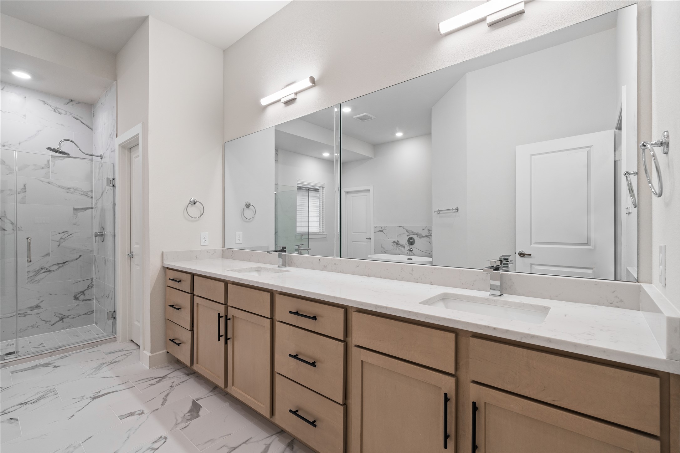 6451 Rena Street Houston, TX 77092 - Photo 22 of 33 A primary bath of this size is uncommon at this price point, offering a wide double sink vanity with extended counter space that comfortably allows for a makeup station or added storage.
