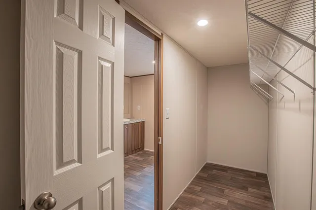 a large kitchen with stainless steel appliances granite countertop a large counter top and a wooden floors