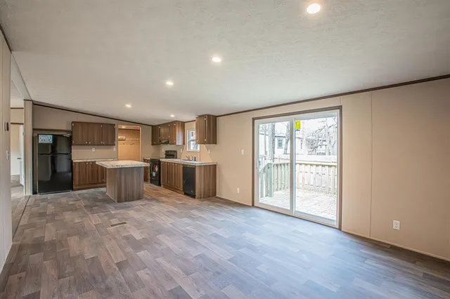 a view of a kitchen with furniture and wooden floor