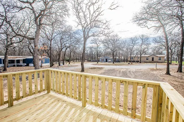a view of kitchen with kitchen island wooden floor center island and stainless steel appliances