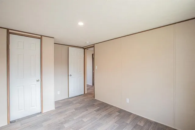 a view of a balcony with wooden floor and fence