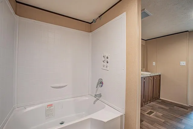 a view of hallway with stairs and wooden floor