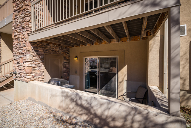 2511 Redcliff Road, Unit 3A Moab, UT 84532 - Photo 21 of 24 Entrance to property featuring stone siding, stucco siding, and a patio