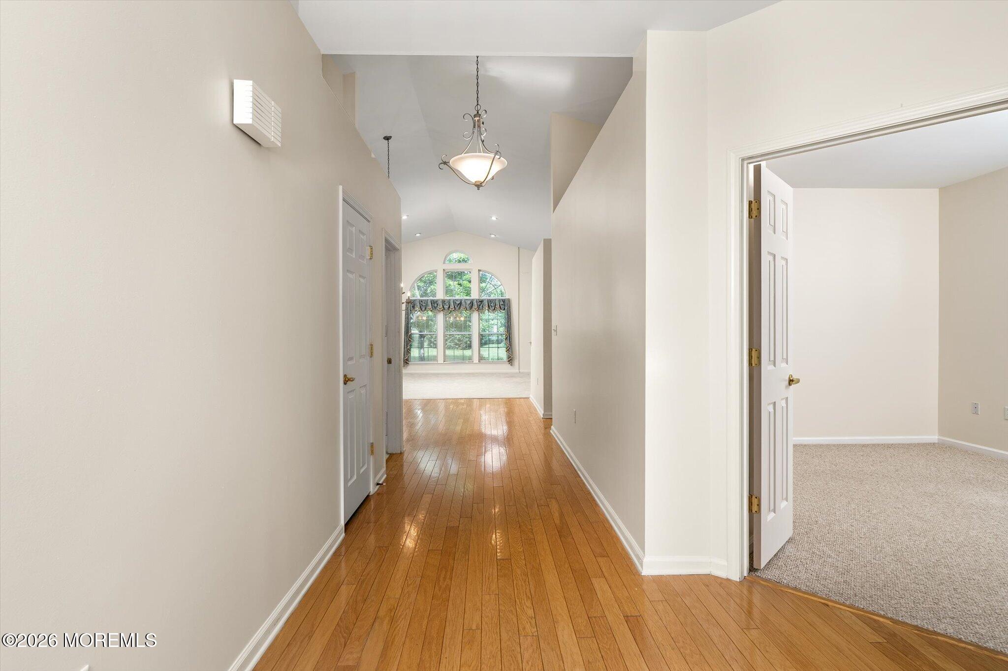 10 Powderhorn Way Allentown, NJ 08501 - Photo 3 of 27 a view of a hallway with wooden floor and a bathroom