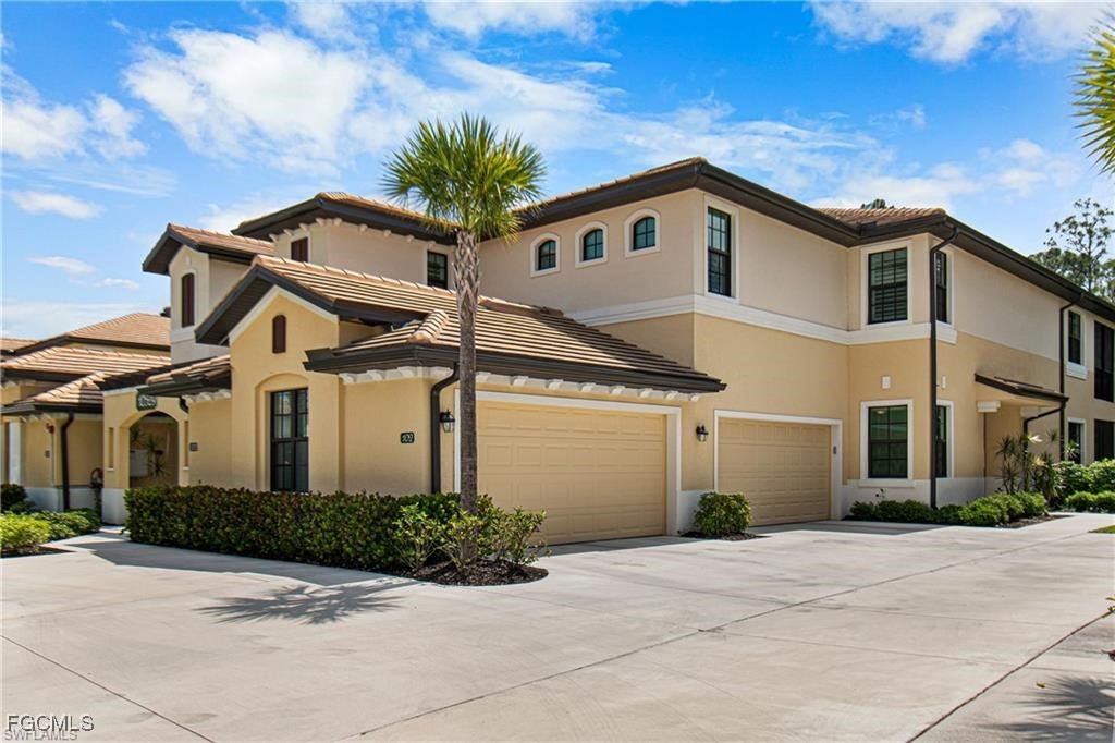 10529 Casella Way, Unit 102 Fort Myers, FL 33913 - Photo 1 of 14 a view of a white house with a small yard and plants