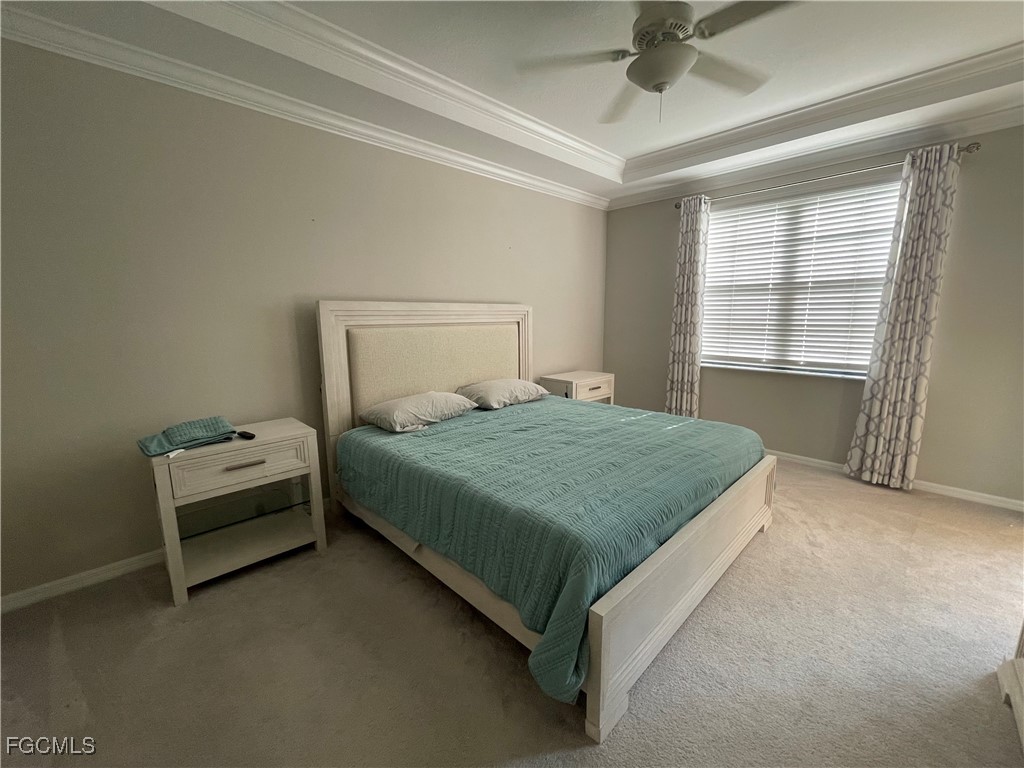 10529 Casella Way, Unit 102 Fort Myers, FL 33913 - Photo 12 of 14 a bedroom with a bed and a chandelier