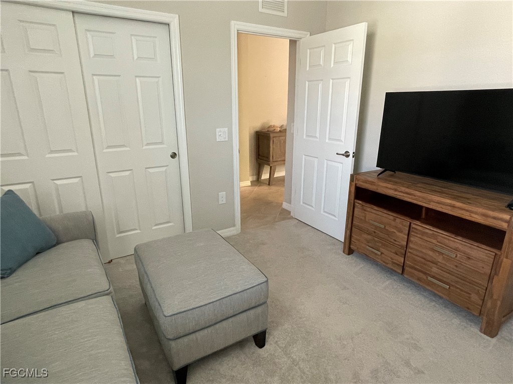 10529 Casella Way, Unit 102 Fort Myers, FL 33913 - Photo 14 of 14 a living room with furniture and a flat screen tv