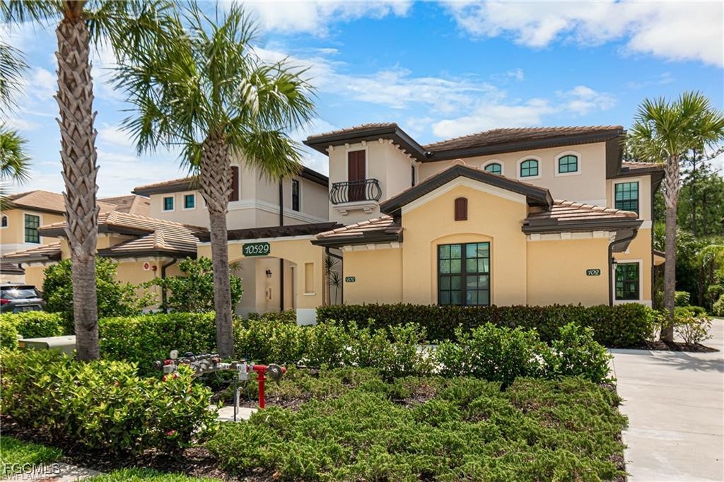 10529 Casella Way, Unit 102 Fort Myers, FL 33913 - Photo 2 of 14 a front view of a house with a garden