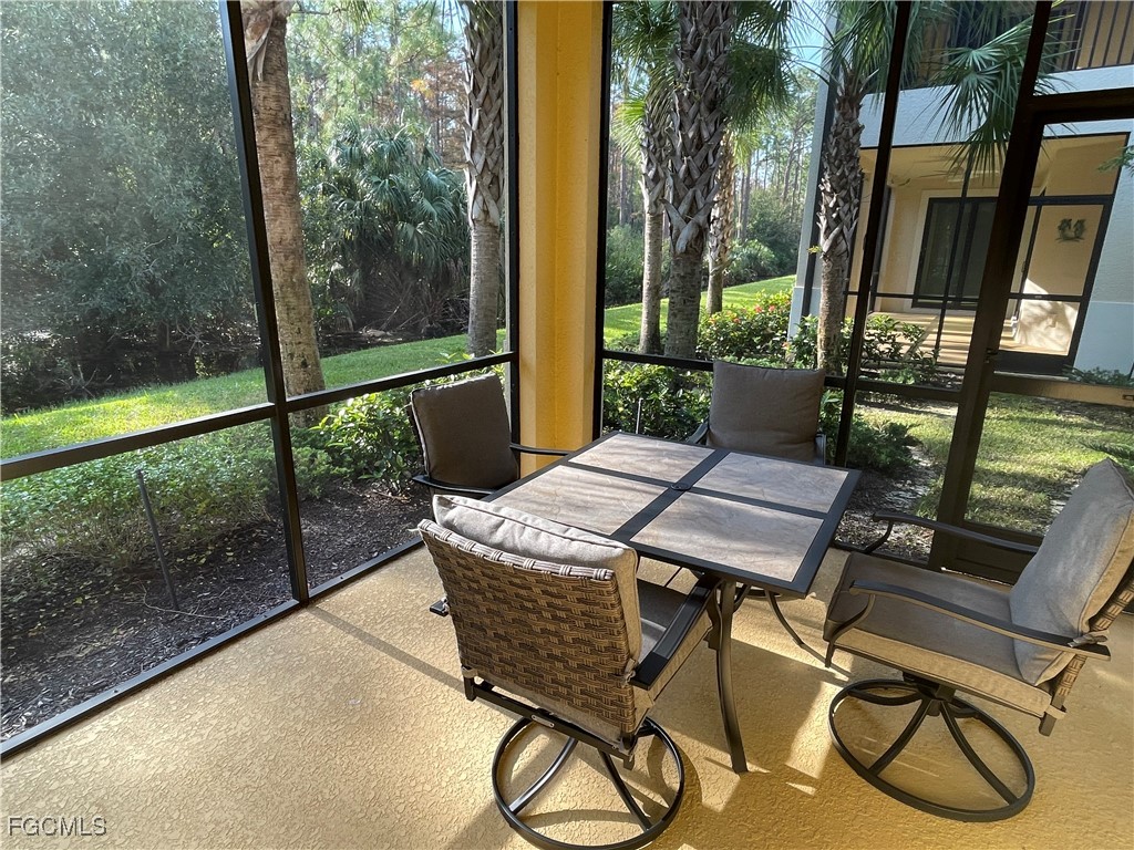 10529 Casella Way, Unit 102 Fort Myers, FL 33913 - Photo 3 of 14 a patio with table and chairs