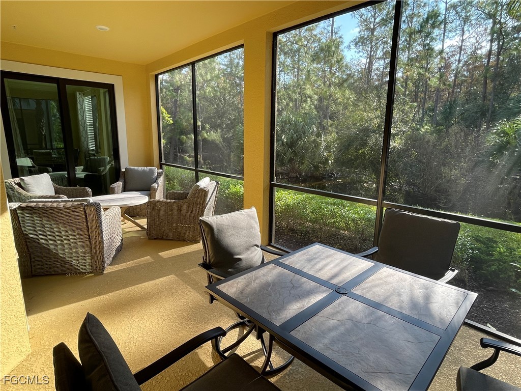 10529 Casella Way, Unit 102 Fort Myers, FL 33913 - Photo 4 of 14 a view of a living room and a porch with furniture