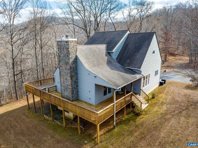 a view of house with roof deck and furniture