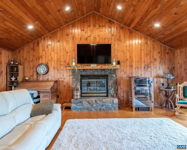 a living room with a couch a dining table and a fireplace