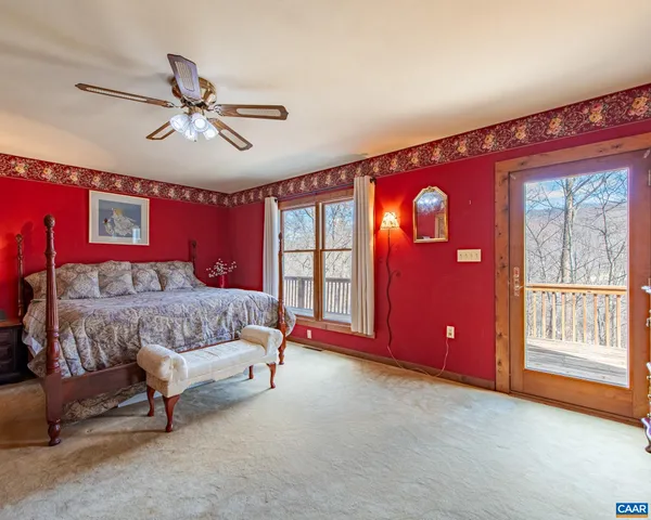 a bed room with a bed and a ceiling fan