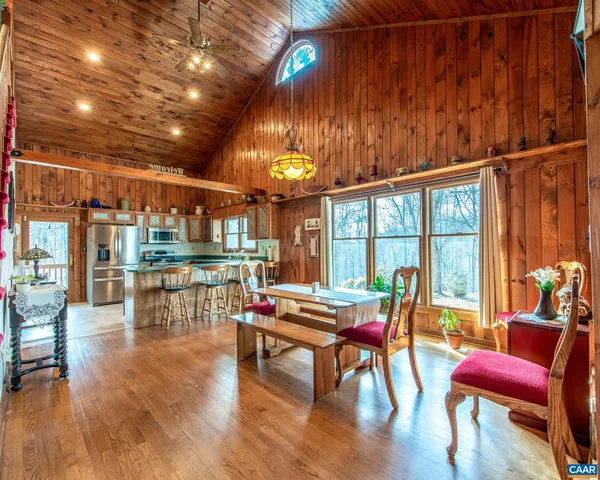 a living room with furniture a fireplace and a floor to ceiling window