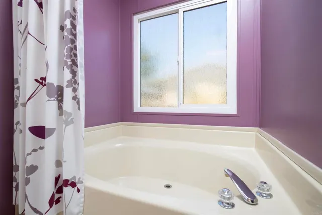 a bath tub sitting next to a window