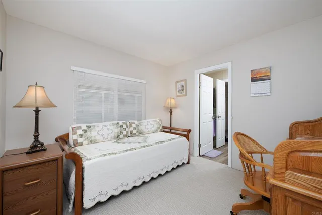 a bedroom with a bed and a lamp