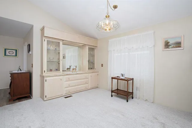 a room with a mirror and a bed