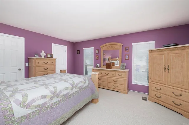 a bedroom with a bed and dresser