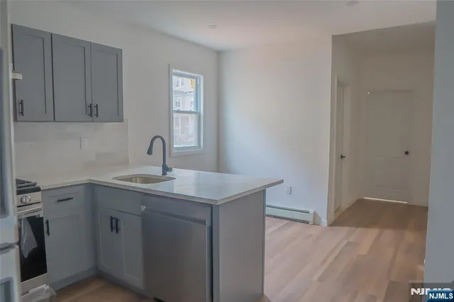 a kitchen with a sink and cabinets