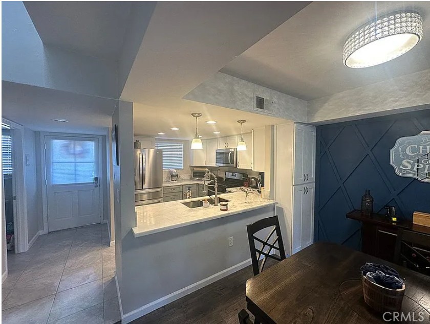 a kitchen with a sink and a stove top oven