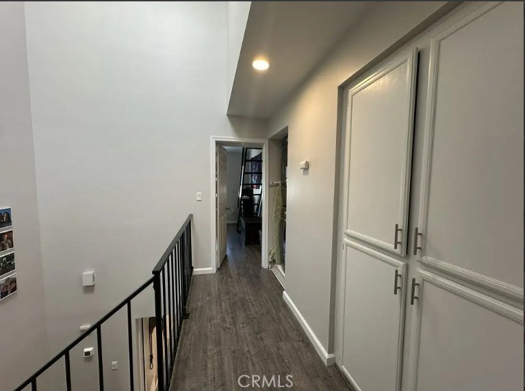 8717 Spring Canyon Drive Spring Valley, CA 91977 - Photo 14 of 34 a view of a hallway with wooden floor and staircase