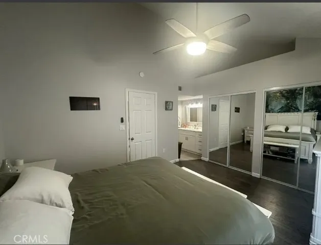 a bedroom with a bed and a tv