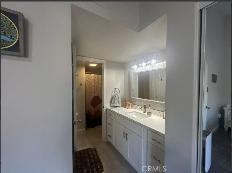 8717 Spring Canyon Drive Spring Valley, CA 91977 - Photo 19 of 34 a bathroom with a double vanity sink and a mirror
