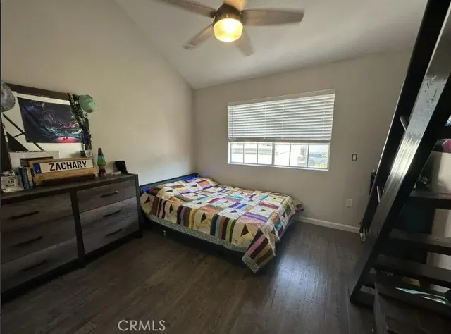 a bedroom with a bed and a flat tv screen on a dresser