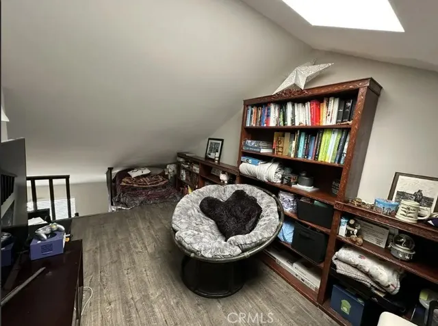 a living room with furniture and a book shelf