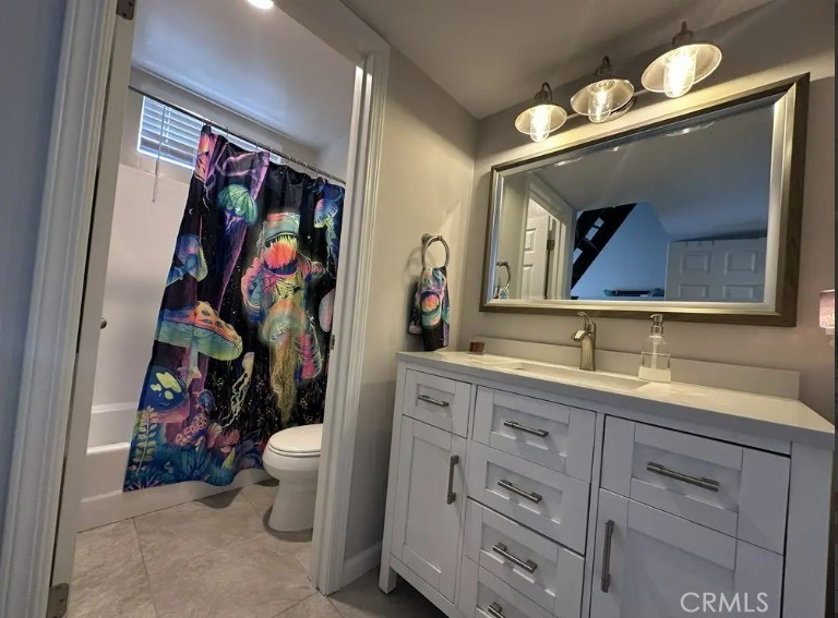 8717 Spring Canyon Drive Spring Valley, CA 91977 - Photo 24 of 34 a bathroom with a toilet a sink and a mirror