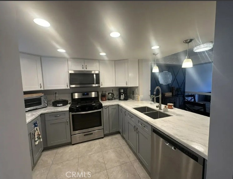 8717 Spring Canyon Drive Spring Valley, CA 91977 - Photo 4 of 34 a kitchen with stainless steel appliances granite countertop a sink a stove and a refrigerator
