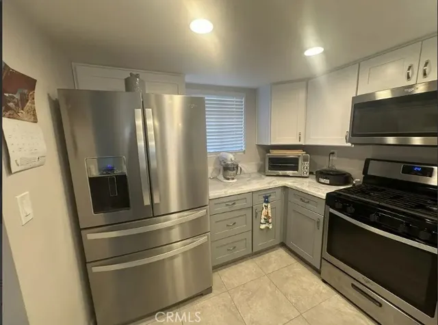 a kitchen with a refrigerator stove and sink