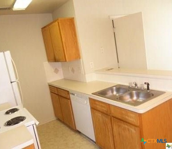 1601 Dugger Circle Killeen, TX 76543 - Photo 4 of 15 a kitchen with a sink a stove and a refrigerator