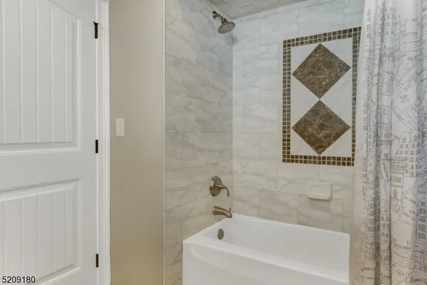 a bathroom with a bathtub and shower