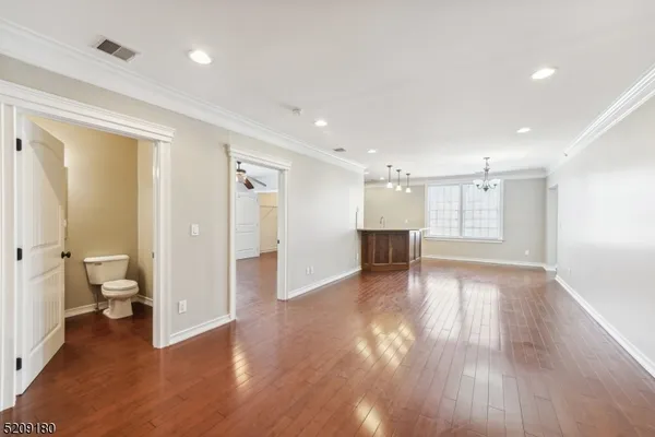 a view of a big room with wooden floor and a bathroom