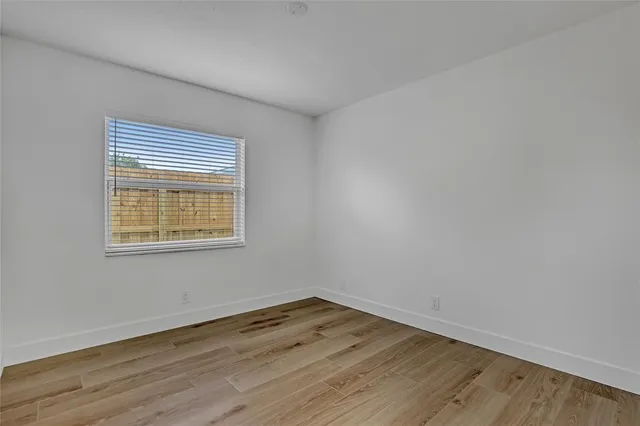 a view of an empty room and wooden floor