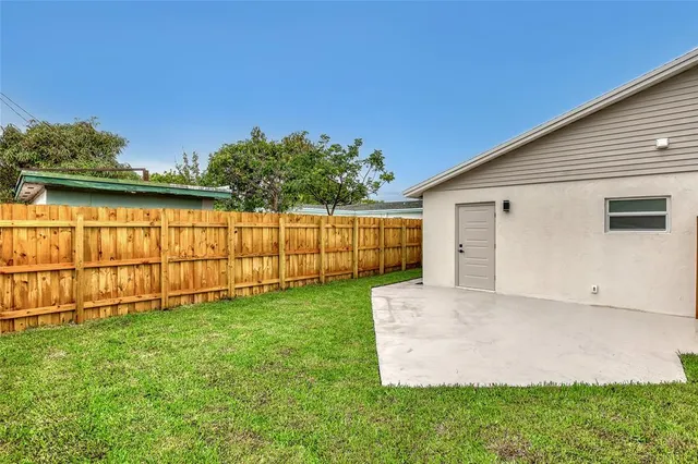 a front view of a house with wooden fence