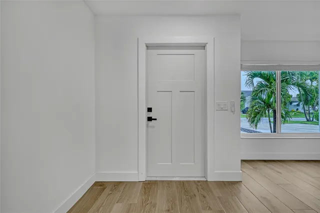 a kitchen with kitchen island granite countertop a sink cabinets and wooden floor
