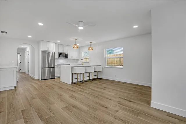 a kitchen with a sink stainless steel appliances and cabinets