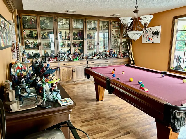 a room with lots of potted plants and large tree
