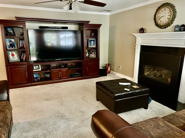 a living room with furniture and a flat screen tv