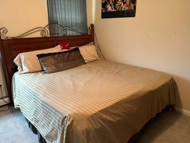 a bedroom with a bed and window